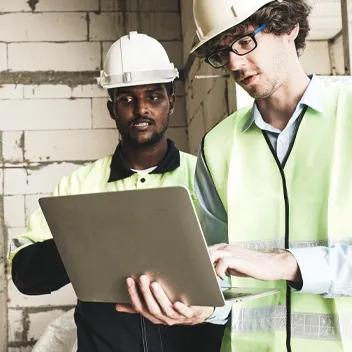 contractors going over a blueprint on public school project